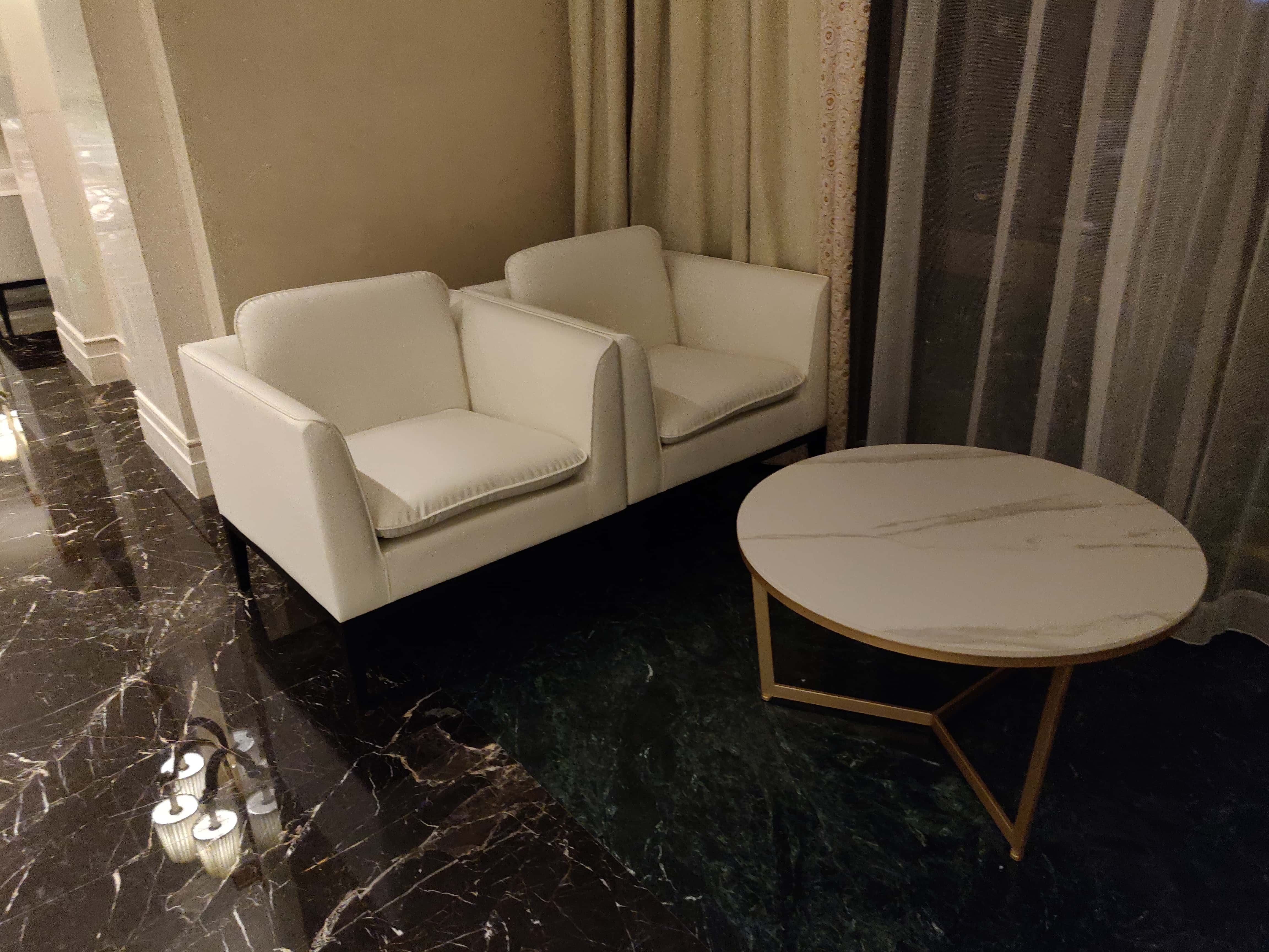 Shanghai premium sofa rental — cream armchairs with marble-look round coffee table and gold metal legs